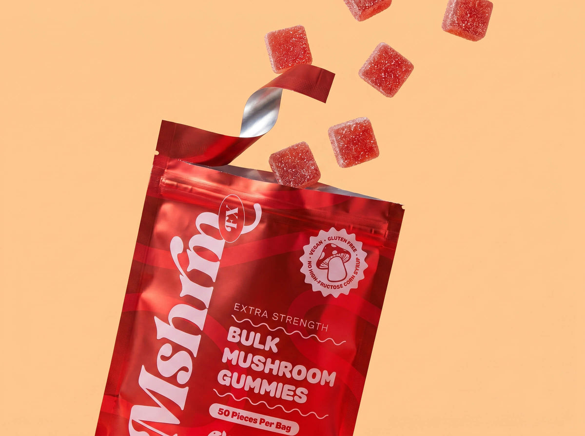 Red package of Mushroom FX bulk mushroom gummies on a peach background